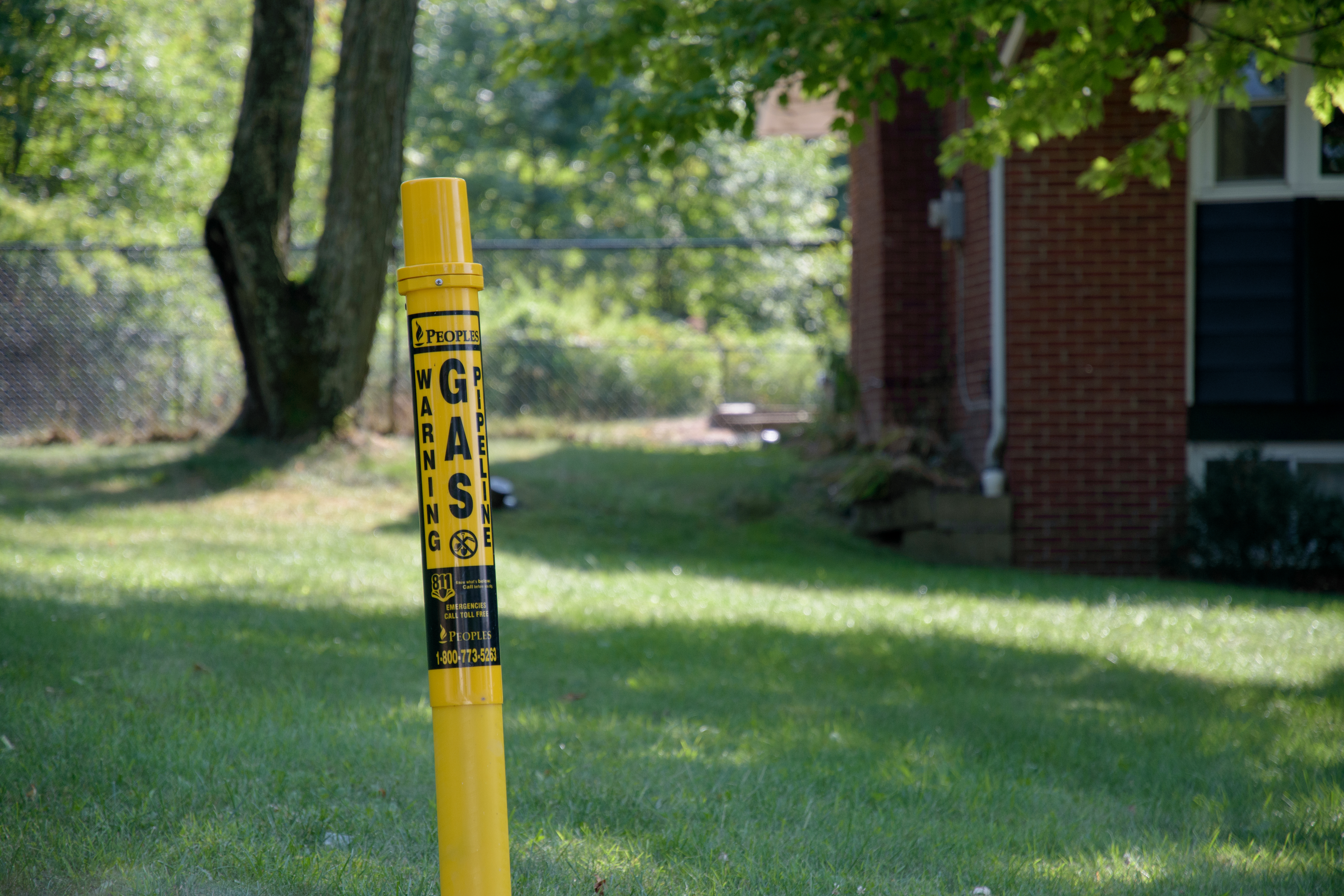 A natural gas pipeline marker in front of a residential home in Monroeville, PA. Pipeline markers can be seen on the side of nearly every road in southwestern PA. 